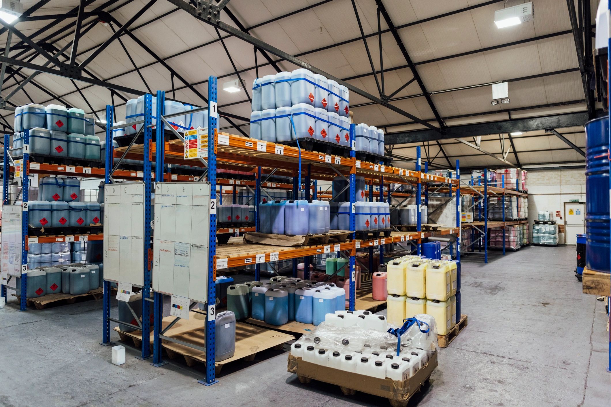 Industrial storage warehouse with packaged coating products ready for dispatch