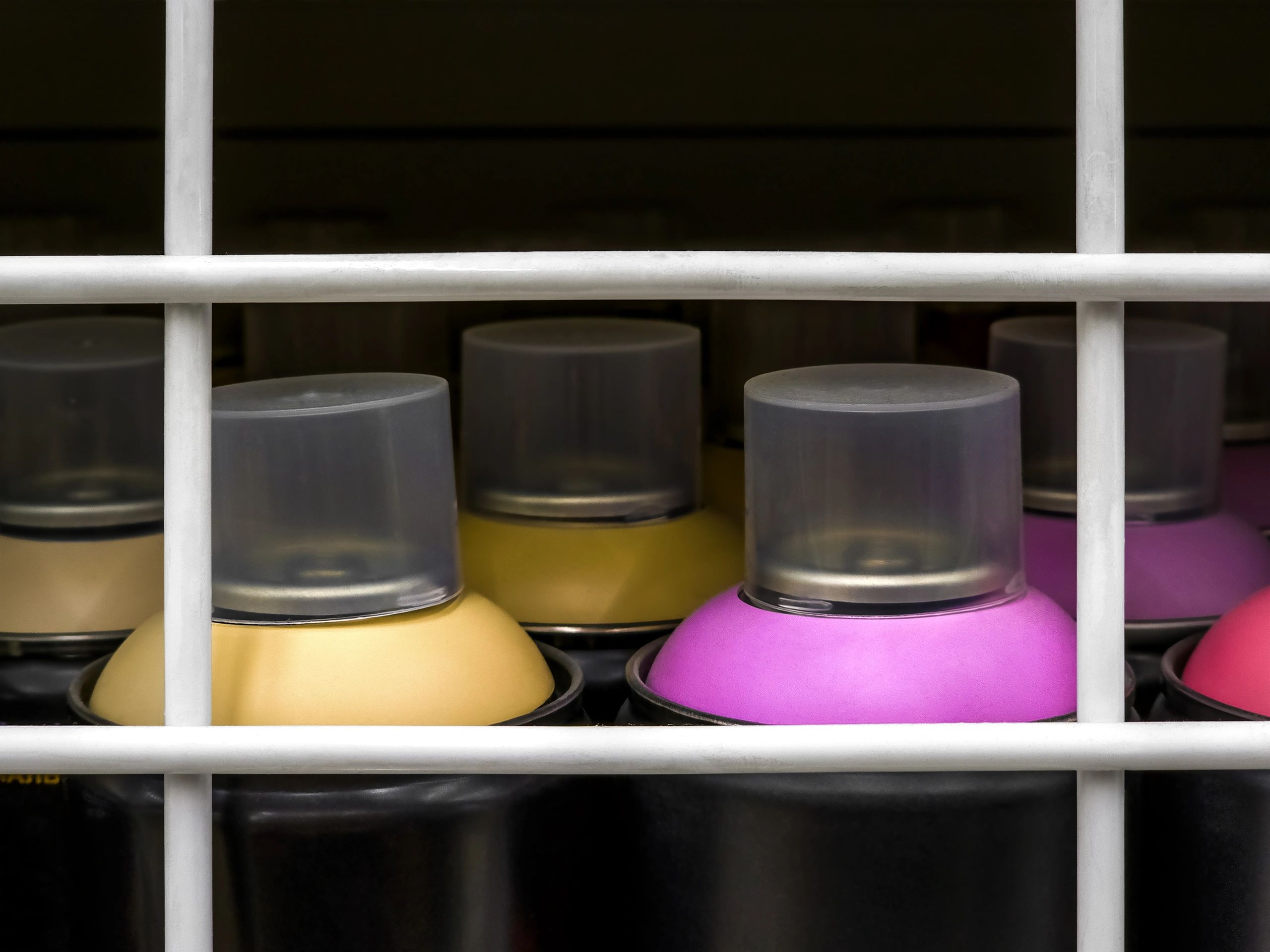Assorted spray paint cans displayed together